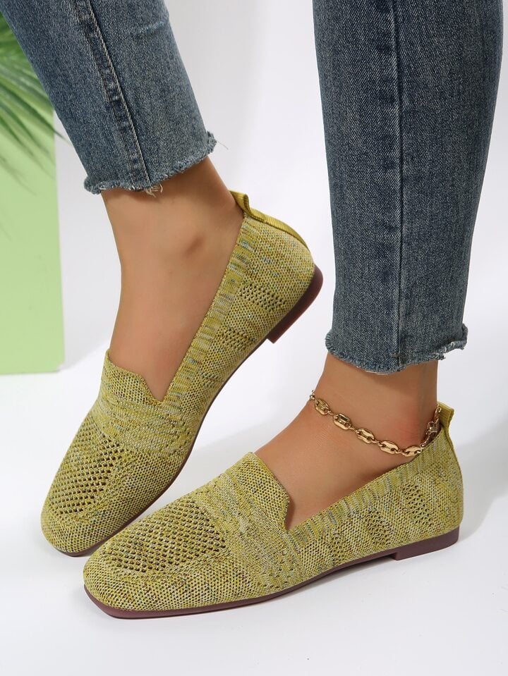 Olive-yellow knit slip-on flats with mesh toe panels and heel tabs, another view.