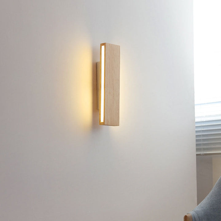Beige and white Japanese-style LED wall light on a white wall, another view beside a window and chair.