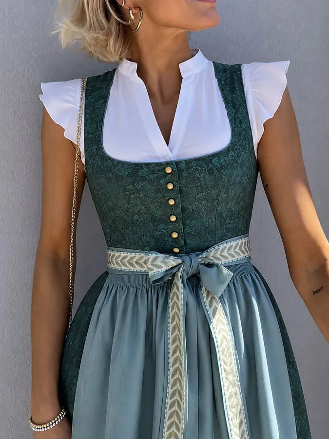 Green woven dress detail with lace-up bodice and curved front hem.