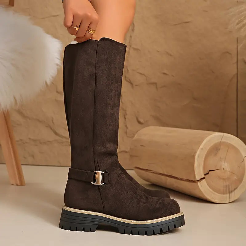 Dark brown tall boot another view with a metal buckle strap and chunky black sole.