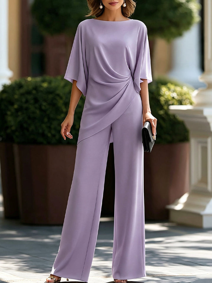 Model wearing the set in soft lilac, with batwing-style sleeves, a draped hem and wide-leg pants. 7