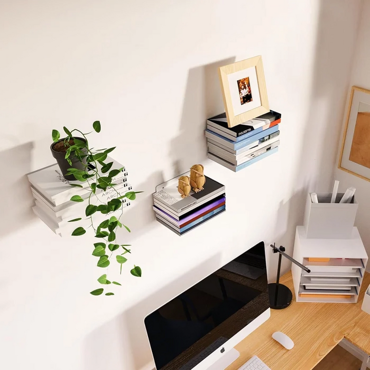 Black floating book shelf with books on a white wall above a desk