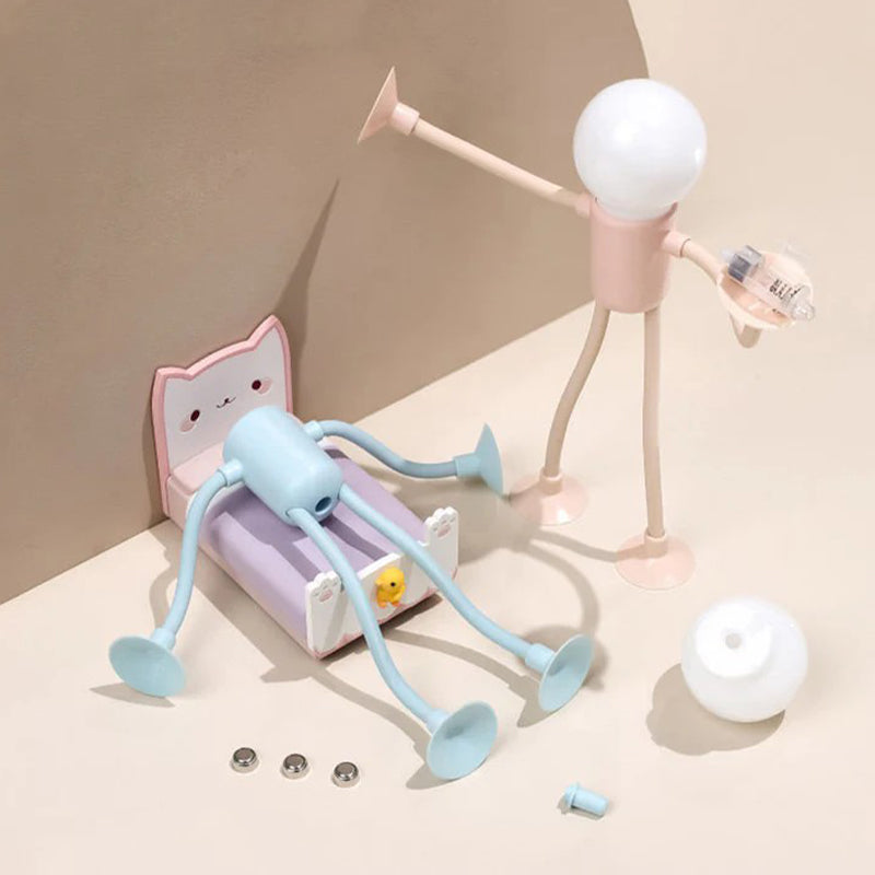 Pink figure lamp being assembled with a blue lamp body, bulb cover and button batteries.