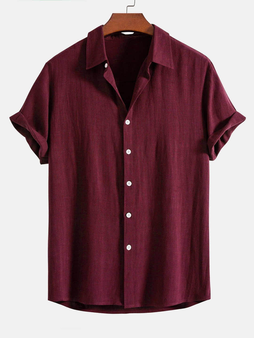 Burgundy short sleeve shirt on a wooden hanger, front view with white buttons and cuffed sleeves.