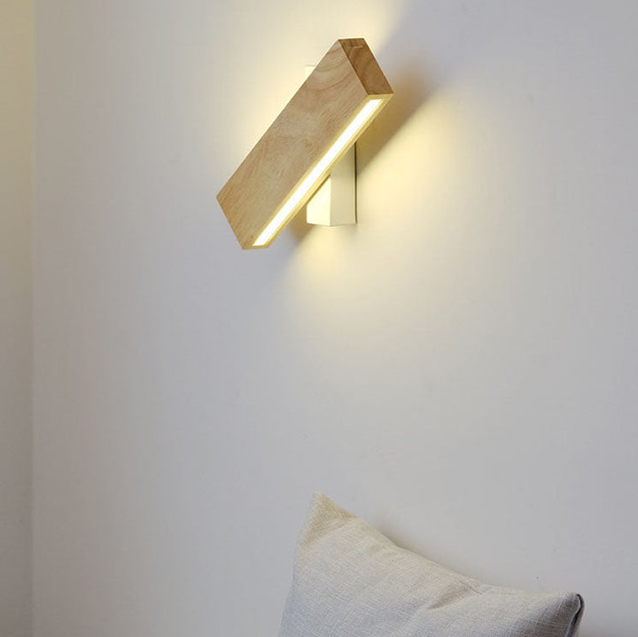 Beige and white Japanese-style LED wall light on a white wall, shown diagonally and lit.