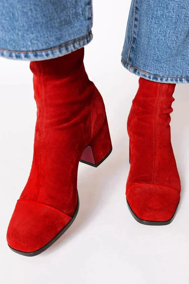 Red leather heeled boots with square toe caps and chunky heel, another view.