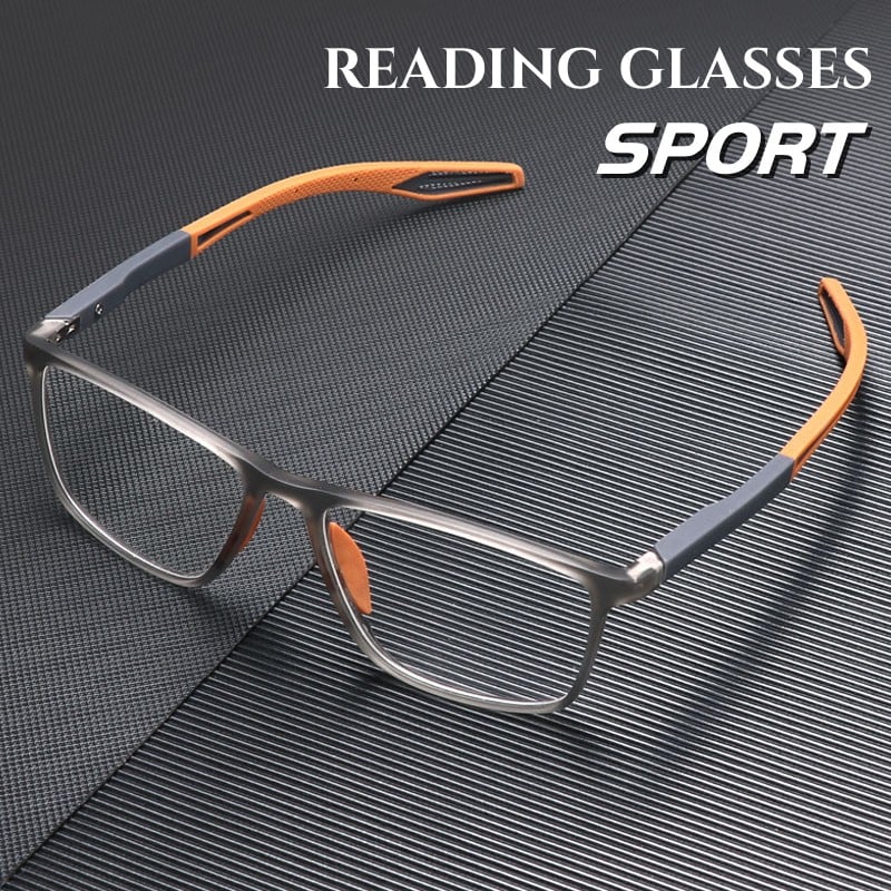 Grey translucent square-framed glasses with orange and grey rubberized temple tips on a dark ribbed surface.