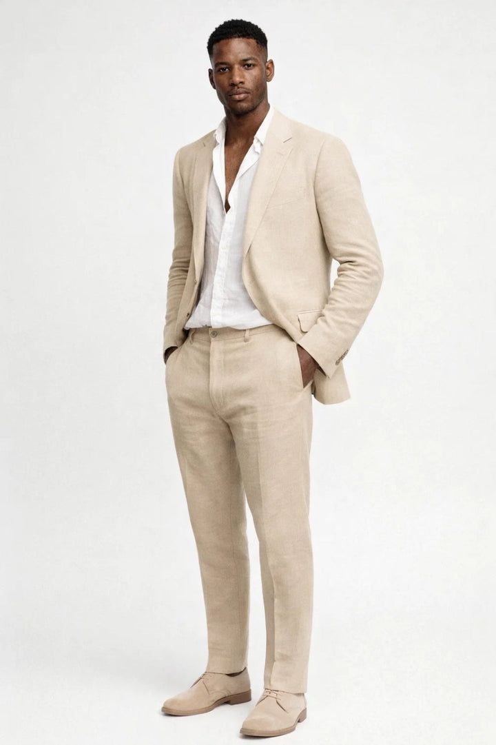 Men's linen suit in beige with a white shirt and matching suede lace-up shoes, shown full-length.