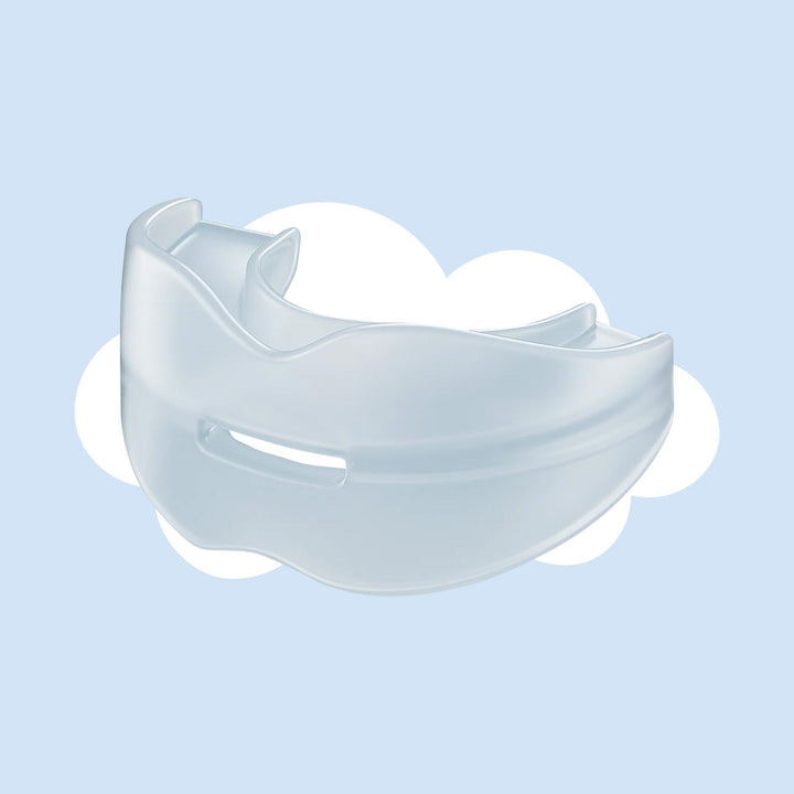 Clear translucent silicone mouthpiece with a small front vent slot, shown at an angle against a soft blue background with a white cloud. 1