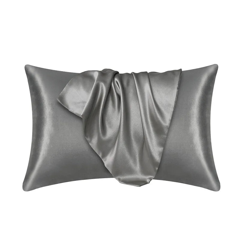 Dark gray pillowcase made of 100% mulberry silk on a plain white background.