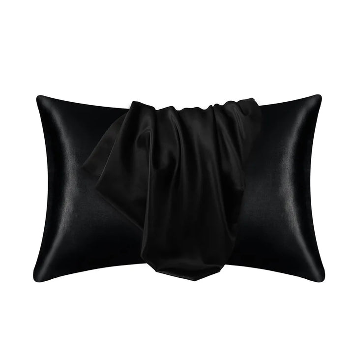 Black pillowcase made of 100% mulberry silk on a plain white background.