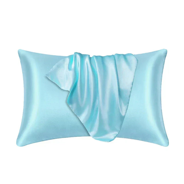 Light aqua blue pillowcase made of 100% mulberry silk on a plain white background.