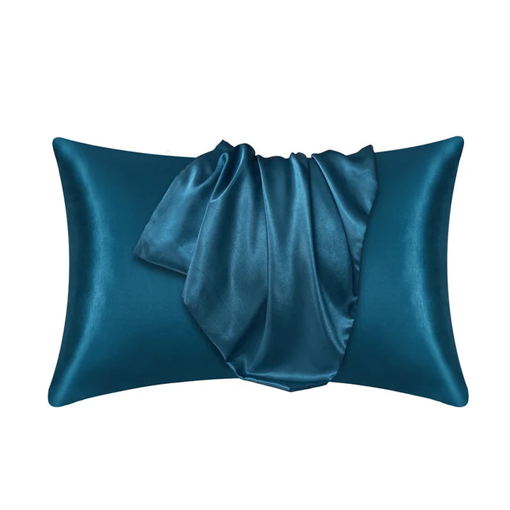 Deep peacock blue pillowcase made of 100% mulberry silk on a plain white background.