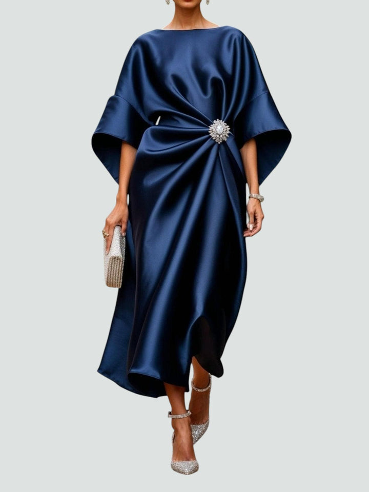 Women’s blue satin maxi dress with cape sleeves and a brooch at the waist