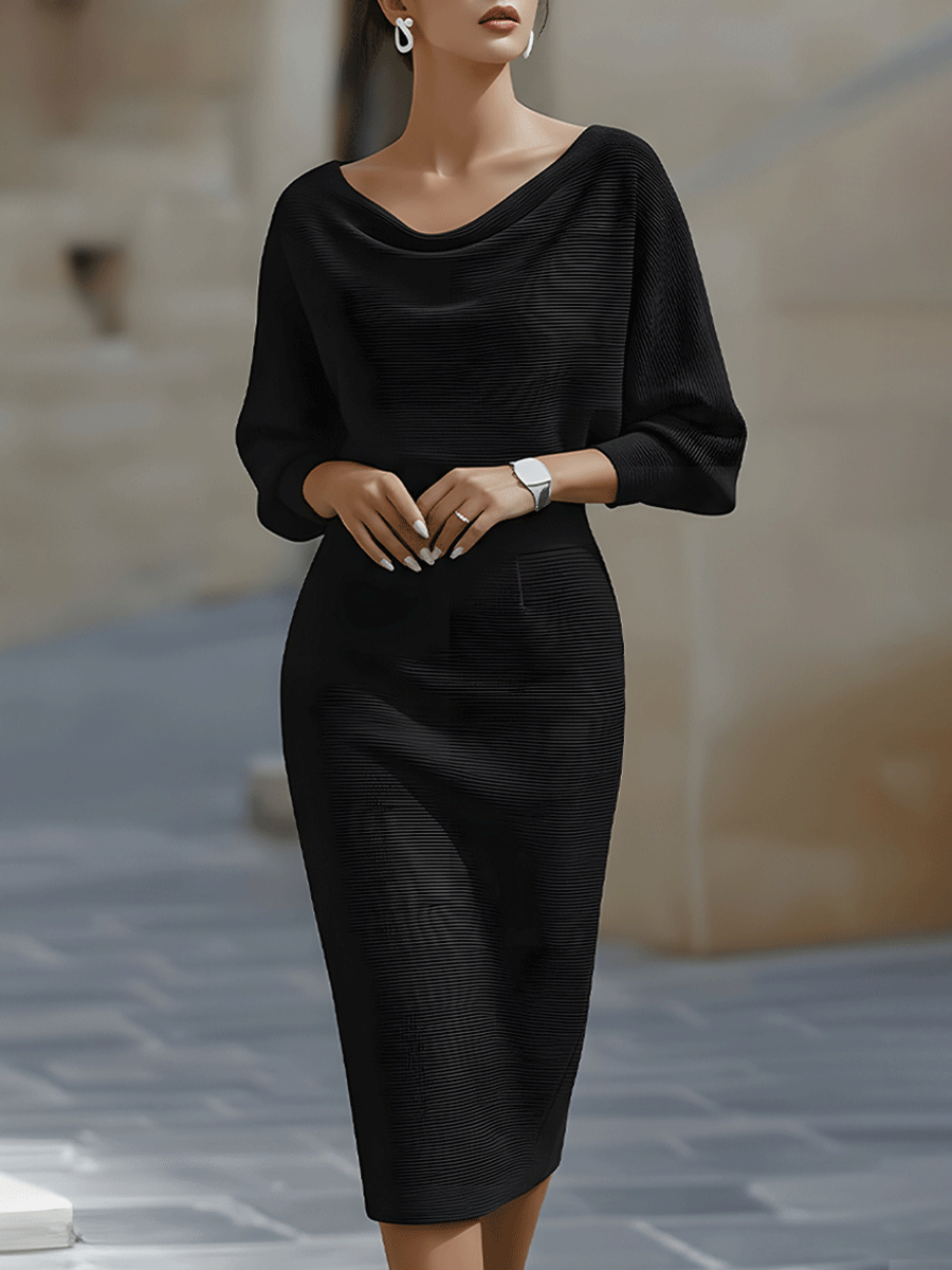 Model wearing the black ribbed knit midi dress with cowl neckline and batwing sleeves, front view 1