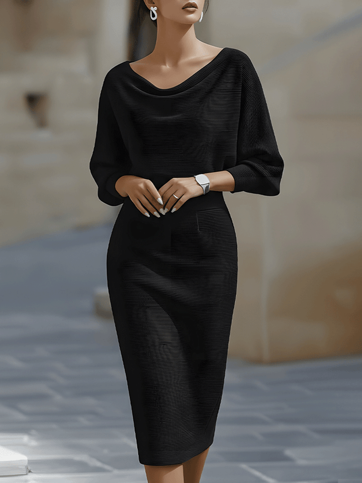 Model wearing the black ribbed knit midi dress with cowl neckline and batwing sleeves, front view 1