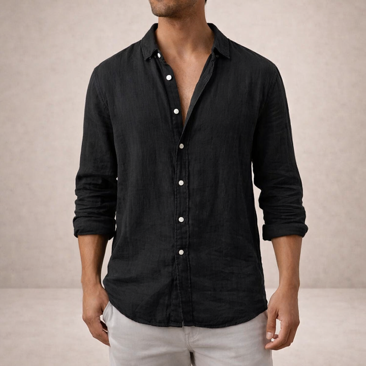 Model in the black linen shirt with sleeves rolled up, white buttons down the placket, light gray pants.