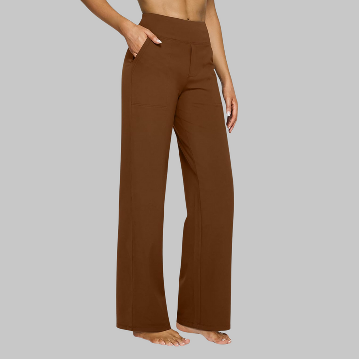 Women's rich rust-brown high-waist straight-leg pants on a model, three-quarter side view showing the patch pocket.