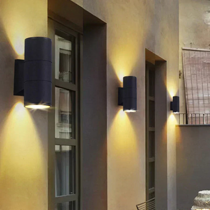 Black LED outdoor wall light, another view, shown in three sizes along a building facade.