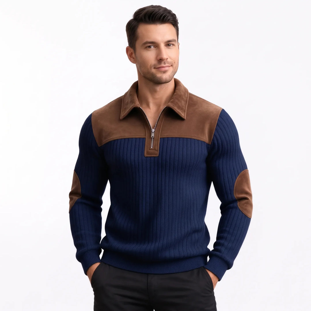 Smiling man wearing the navy ribbed pullover with brown suede-look yoke and half zip, hands in pockets 10