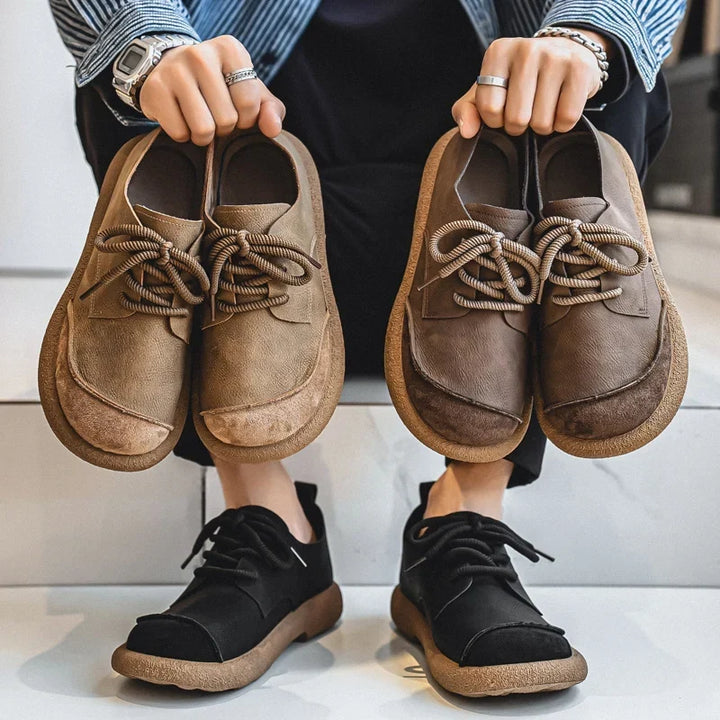 Person holding khaki and brown pairs up while wearing the black pair 10