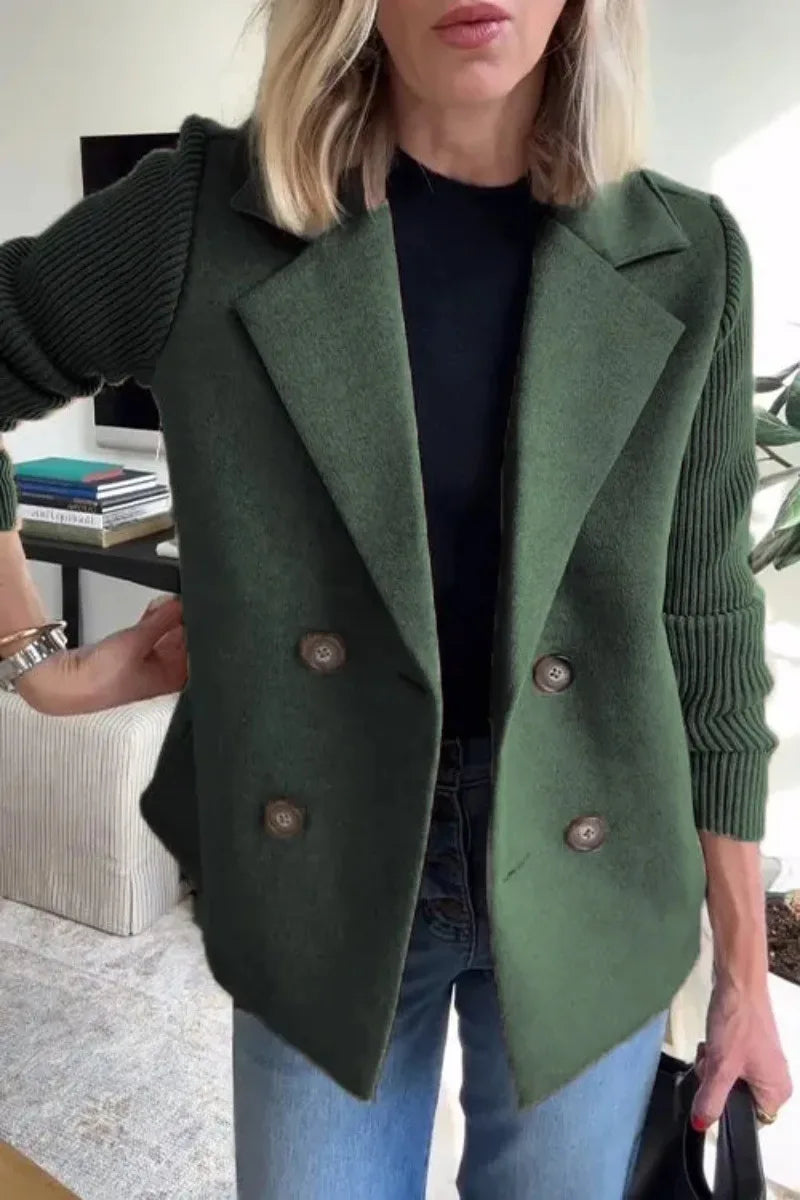 Close-up of dark green jacket with notched lapels, four buttons and ribbed sleeves worn with jeans 10