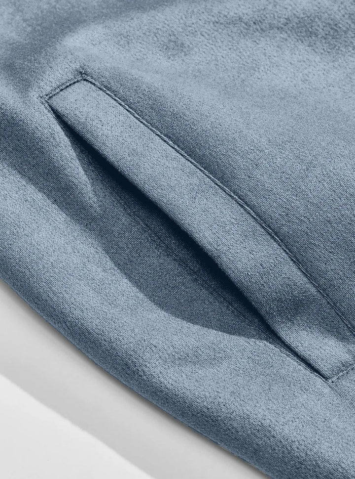 Close-up of the blue jacket's slanted side pocket with neat stitching on the soft textured fabric 10
