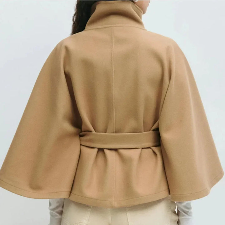 Close back view of the camel cape jacket with center back seam and gathered belted waist 10