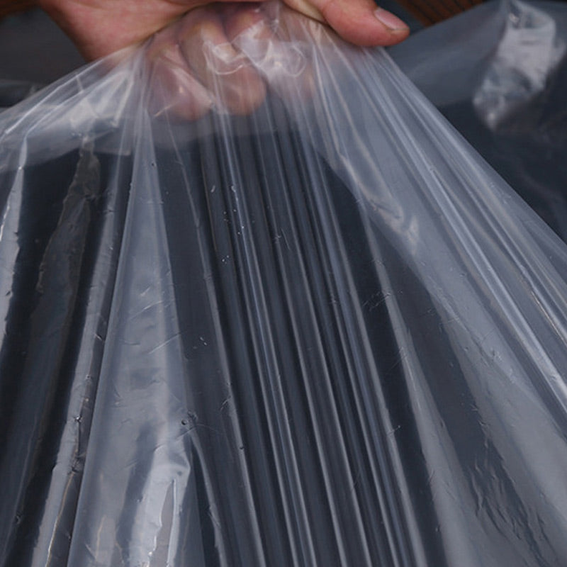 Hand gathering the transparent sheet into folds.
