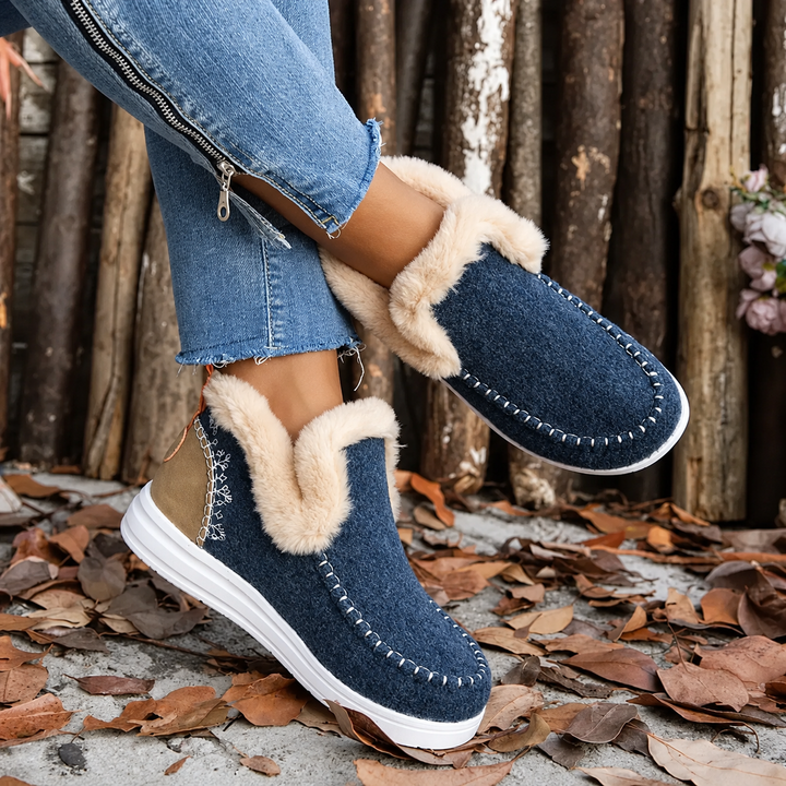 Navy blue textured slip-ons with plush lining, worn with one leg crossed over the other 4