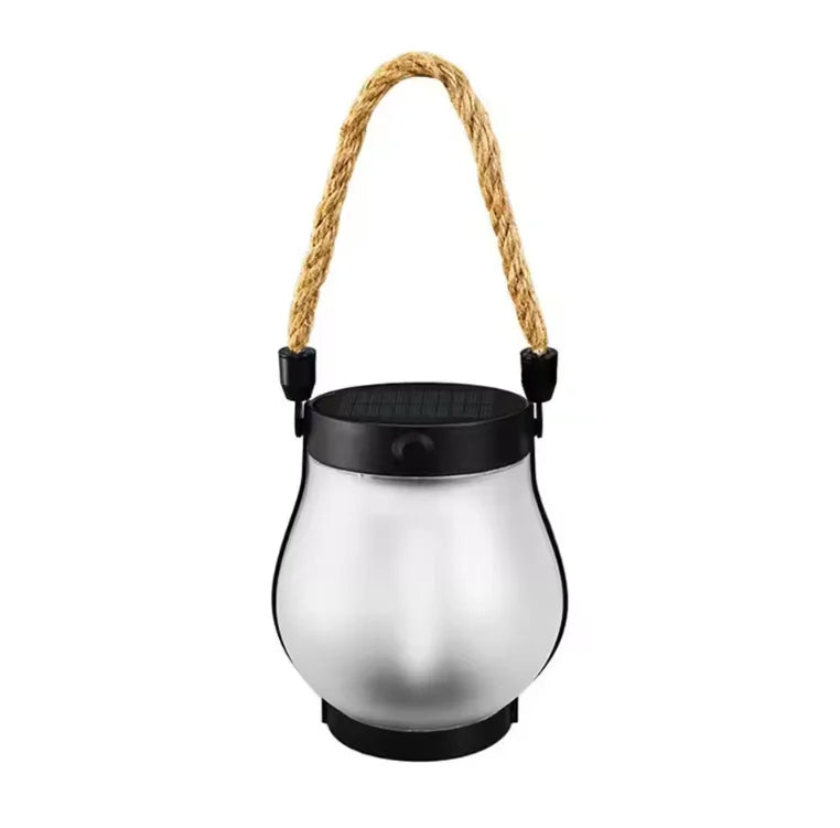 Frosted glass lantern with black solar lid and rope handle, unlit, on a white background 11