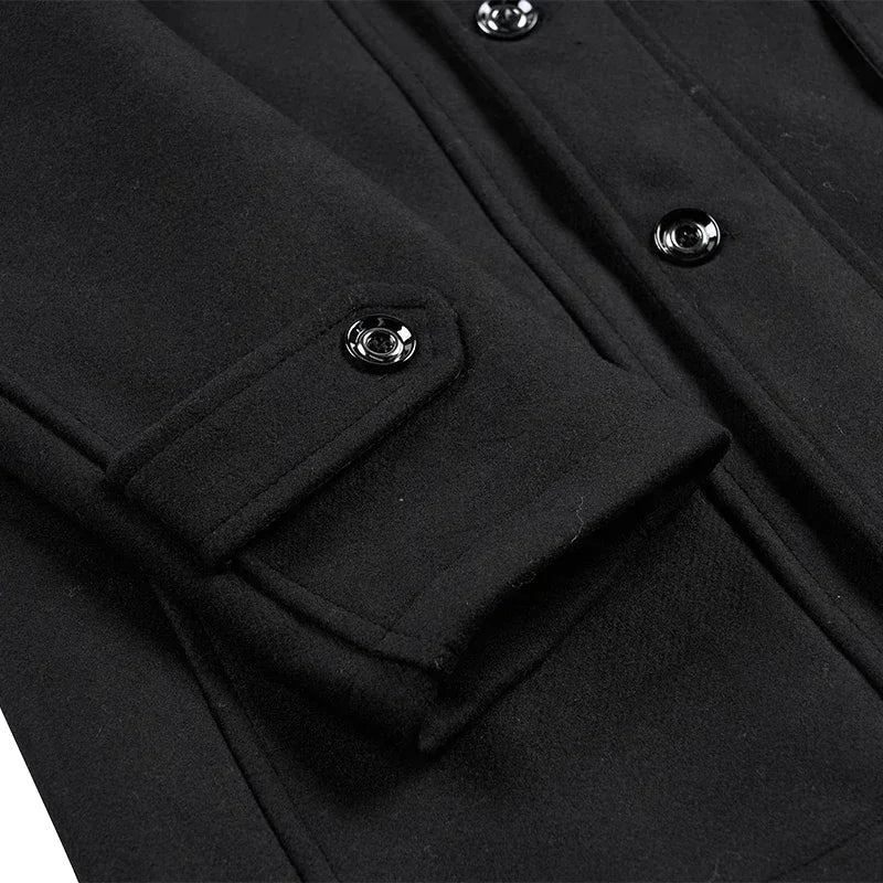 Close-up of a black coat sleeve tab with a glossy snap button and front buttons 11