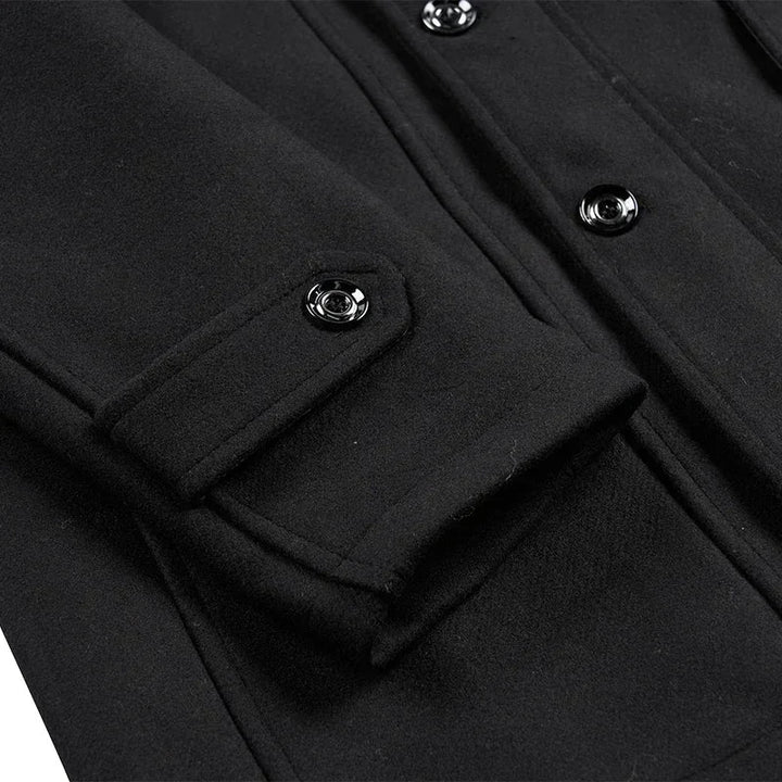 Close-up of a black coat sleeve tab with a glossy snap button and front buttons 11
