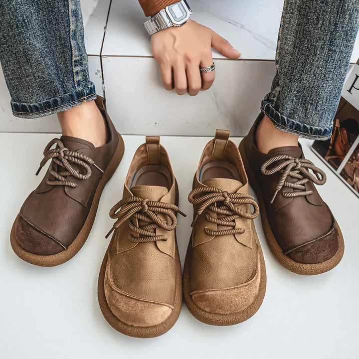 Brown and khaki shoe pairs shown from above next to a seated person in jeans 11