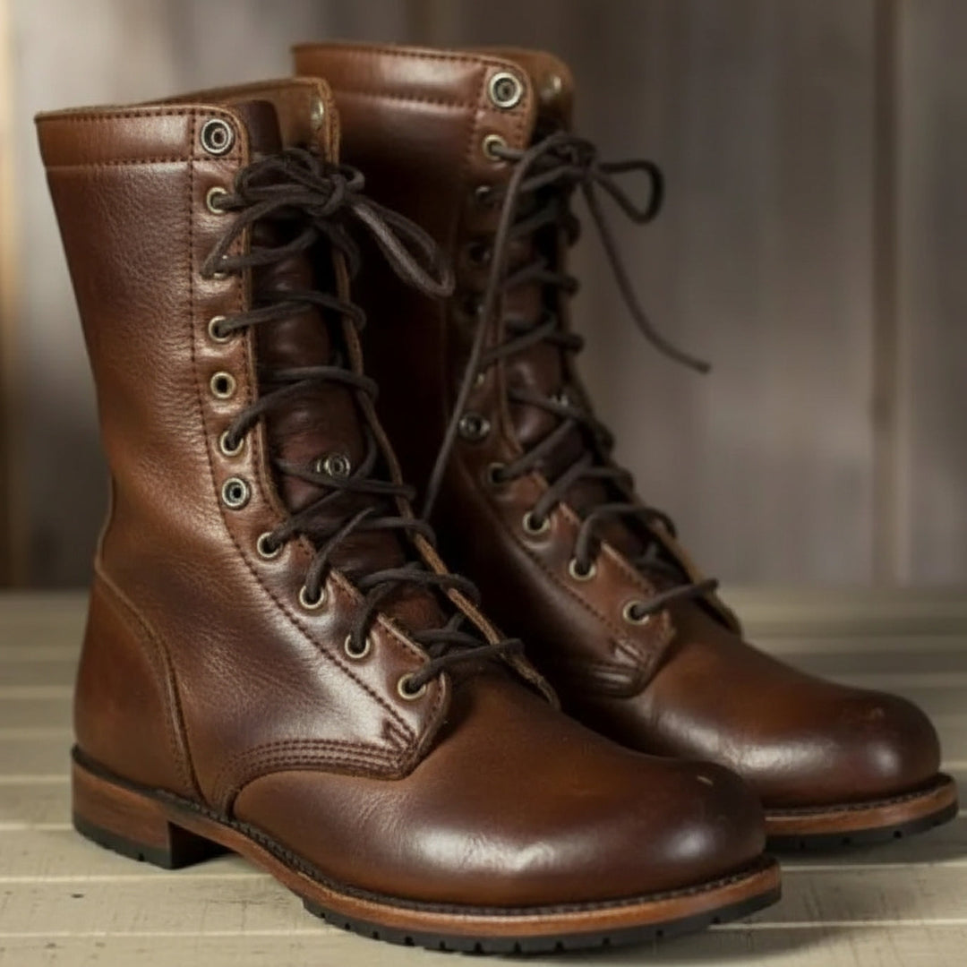 Pair of brown leather lace-up boots with dark laces and metal eyelets, standing side by side on a light wooden surface. 1