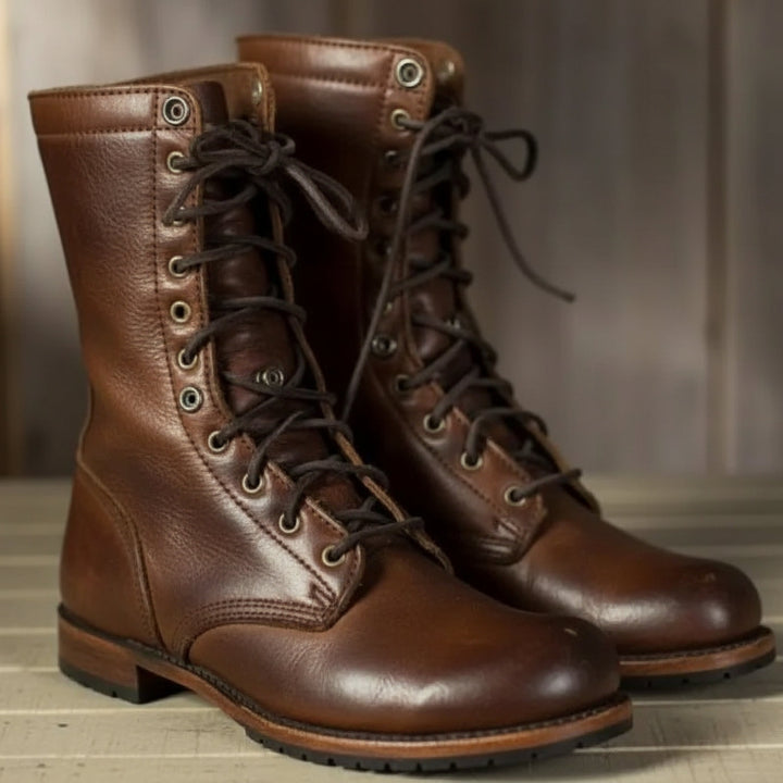 Pair of brown leather lace-up boots with dark laces and metal eyelets, standing side by side on a light wooden surface. 1