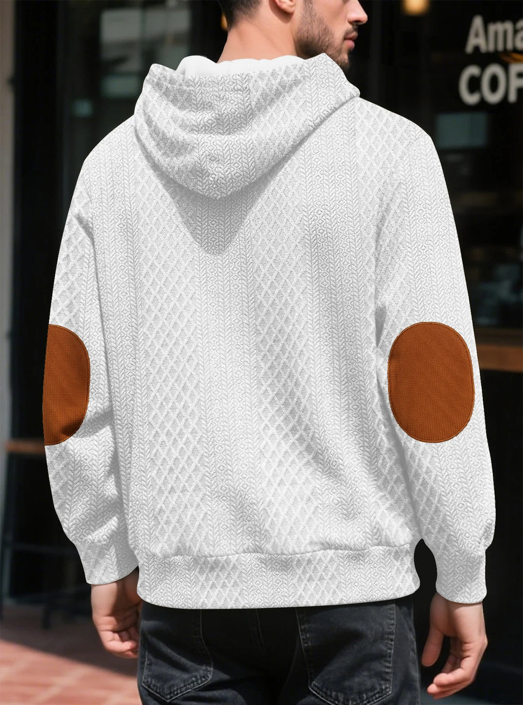 Back view of a man in a white textured hoodie showing large brown elbow patches and ribbed hem 11