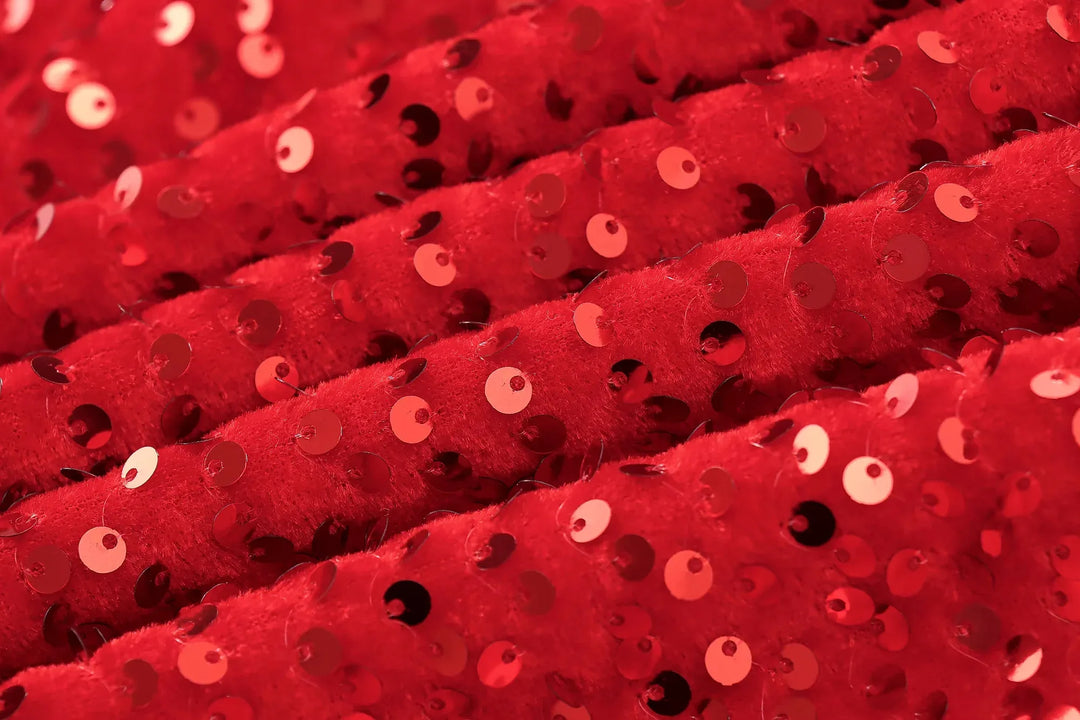 Close-up of red velvet fabric covered in shiny red sequins 11