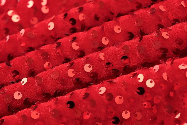 Close-up of red velvet fabric covered in shiny red sequins 11