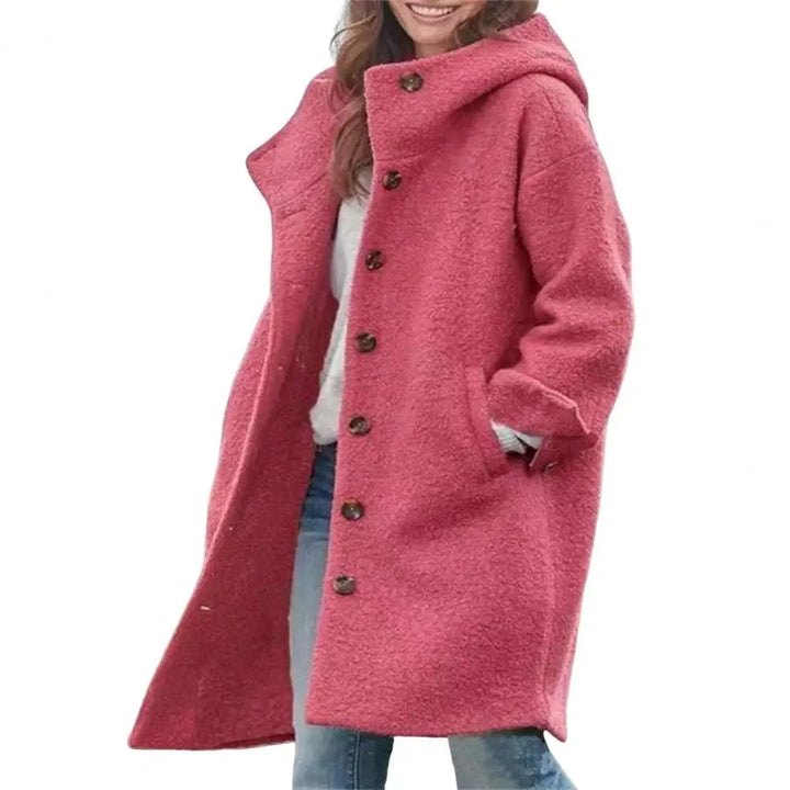 Coral pink hooded coat with large brown buttons and hand in pocket, plain white background 11