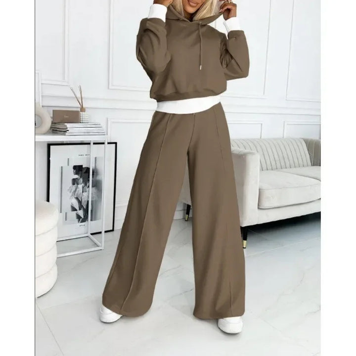 Full-length view of a model in a brown hooded top and wide-leg pants with white cuffs 11