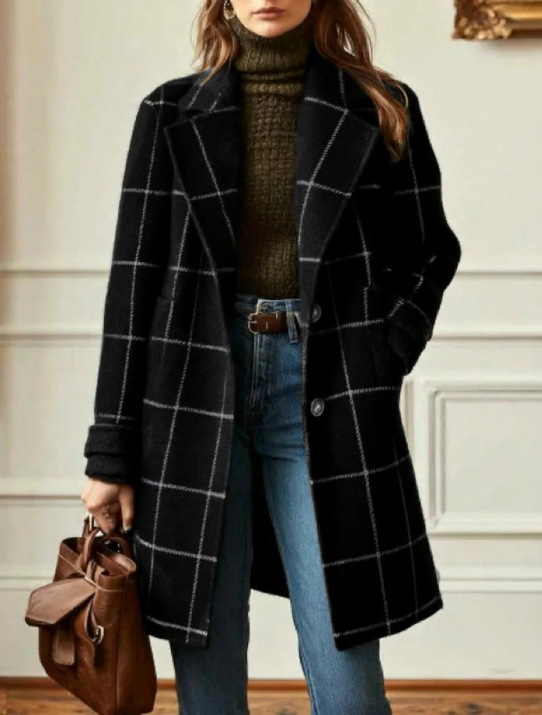 Black coat with white check lines worn over a turtleneck and jeans, brown bag in hand 11