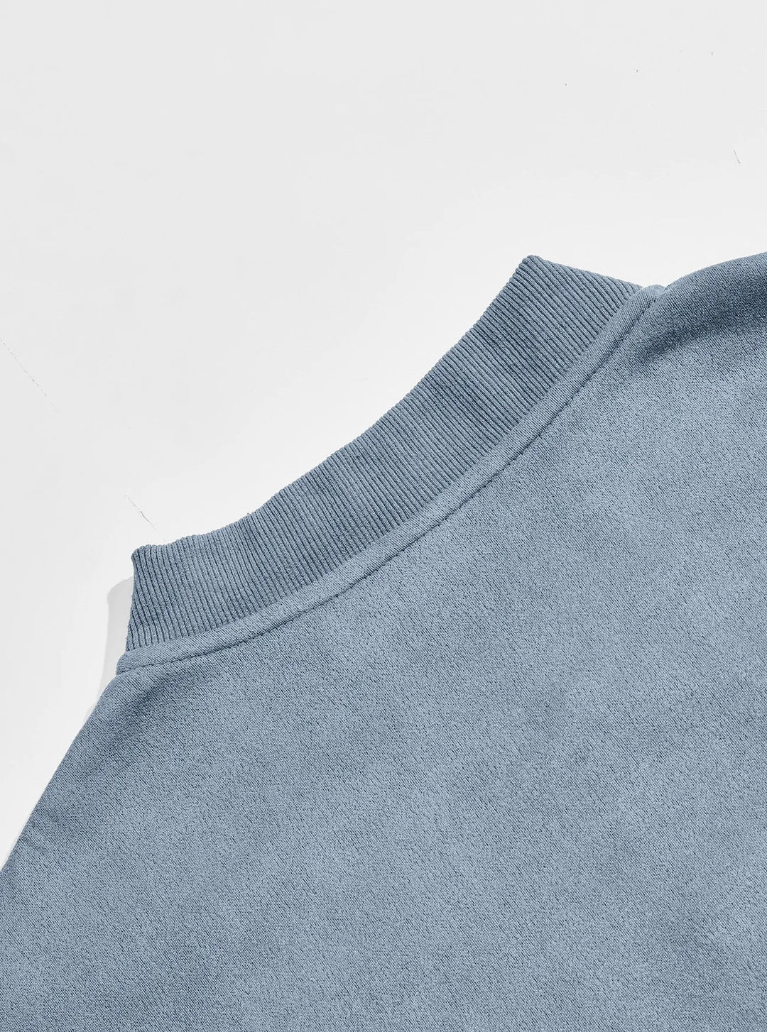 Back view close-up of the ribbed stand collar and shoulder of the blue jacket 11