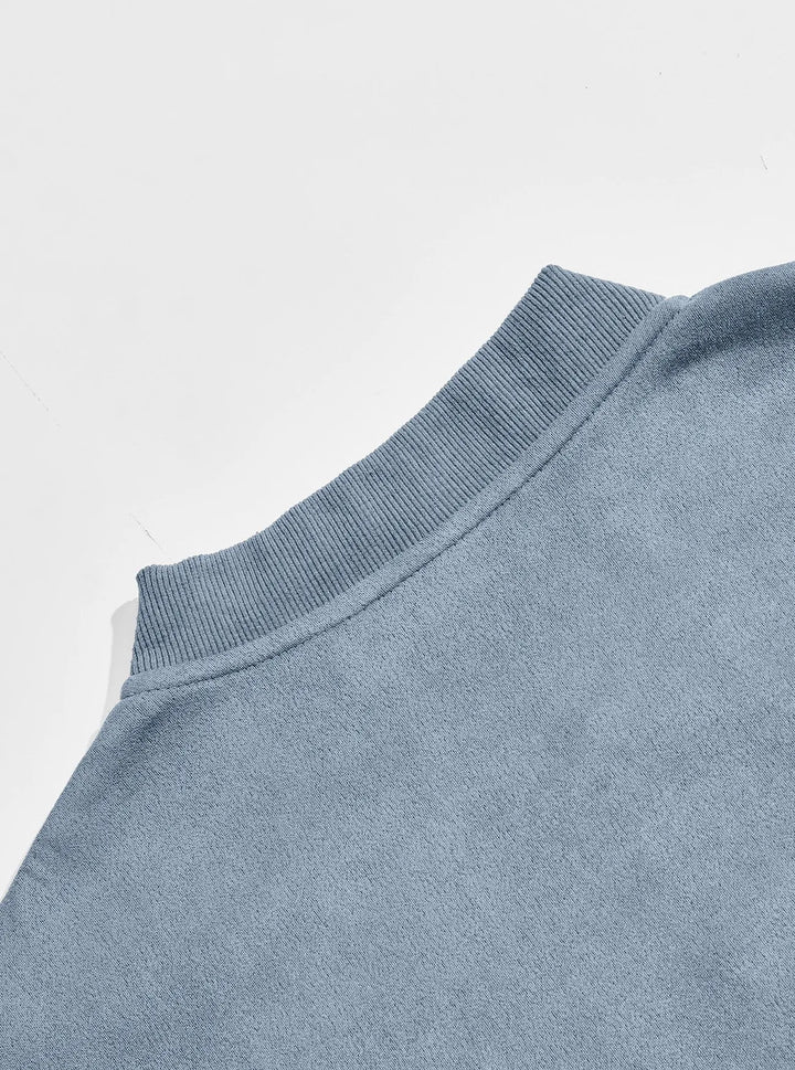 Back view close-up of the ribbed stand collar and shoulder of the blue jacket 11