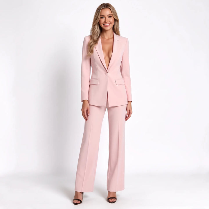 Smiling model in the light pink suit with a deep V neckline and creased wide-leg pants 12