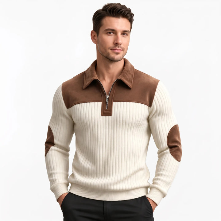 Man wearing the cream ribbed pullover with brown collar, yoke and elbow patches, paired with black pants 12