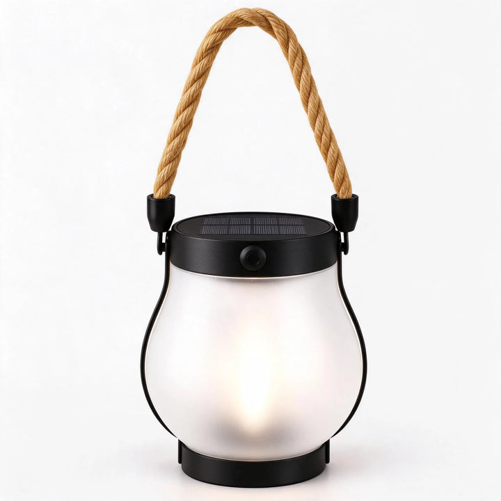 Frosted glass lantern with solar top and rope handle, softly glowing warm white inside 12