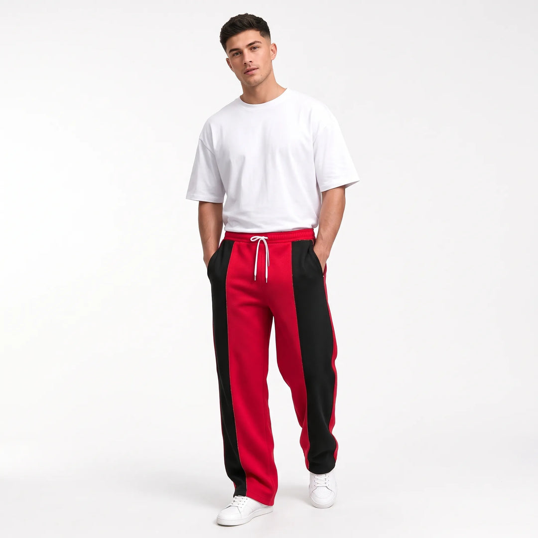 Model in red and black paneled sweatpants with white drawstring, tee and sneakers 12