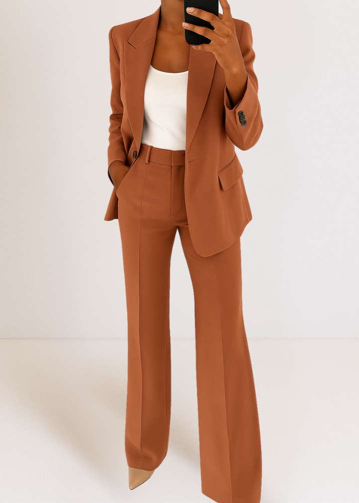 Women's tailored blazer and pants coord set in rust orange, worn over a white top, mirror selfie