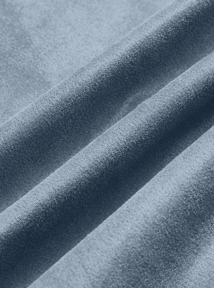 Close-up of the blue jacket fabric draped in soft folds, showing its fine brushed texture 12